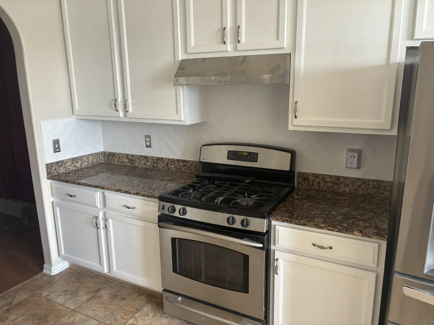 Completed kitchen cabinet and backsplash renewal